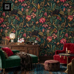 May include: A room interior featuring dark jungle-themed wallpaper with leopards, monkeys, and tropical flowers. A green velvet chaise lounge with a faux fur throw, a red velvet armchair, a wooden sideboard, and a patterned ottoman are present.