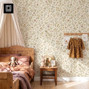May include: Wallpaper featuring a dense botanical pattern of small flowers and leaves in muted green, yellow, and pink tones on a cream background. The design covers the wall behind a wooden bed frame, a wooden nightstand, and a hanging dress.