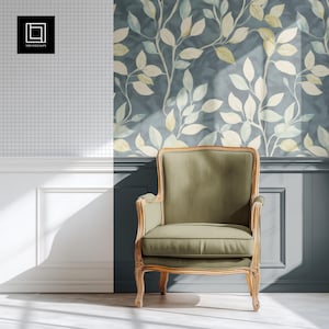 May include: A green upholstered armchair with a wooden frame sits in front of a wall with a blue and white floral wallpaper. The chair has a high back and curved arms.