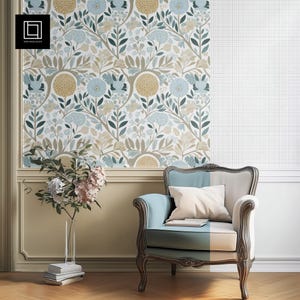 Może przedstawiać: Jasnoniebieski fotel z białą poduszką stoi przed ścianą z tapetą w kwiatowy wzór. Tapeta przedstawia niebieskie i żółte kwiaty na białym tle.