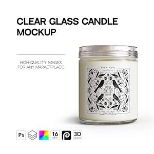 May include: A clear glass candle jar with a white label featuring a black and white design of birds and floral patterns. The label text reads "AREATHORS", "GHATME GBALE", and "LANS SEATY BURD".