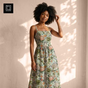 May include: A light green sleeveless midi dress featuring a repeating pattern of lemurs, tropical flowers, and palm leaves. The dress has a square neckline, thin shoulder straps, and a fitted bodice that flows into a full, gathered skirt.
