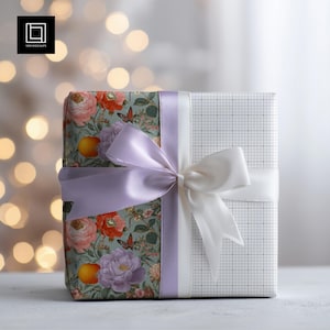 May include: A wrapped gift box with a floral pattern on one side and a grid pattern on the other. The box is tied with a white bow and a lavender ribbon. The floral pattern includes pink and orange flowers, butterflies, and oranges.