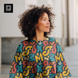 May include: A dark blue top with a colorful pattern of yellow, red, and teal shapes. The top has a crew neck and a loose fit. The design includes letters and abstract shapes. The image also includes the logo of 1001 Mockups.