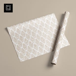 May include: A roll of patterned paper and a flat sheet, with a repeating geometric design in off-white and beige. The pattern features stylized leaf shapes in a diamond grid. The paper is displayed on a neutral background. The logo "1001 Mockups" is in the top left corner.