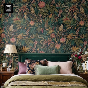 May include: A bedroom scene featuring a dark green headboard and bed with a green duvet. The wallpaper is a jungle design with monkeys, snakes, and flowers. Decorative pillows in various colours and textures are on the bed.