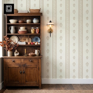 May include: A tall, dark wood hutch with open shelving and lower cabinets, filled with ceramic bowls, plates, glassware, jars of preserved food, and a pitcher. A wall-mounted lamp with a white shade is positioned to the right of the hutch.