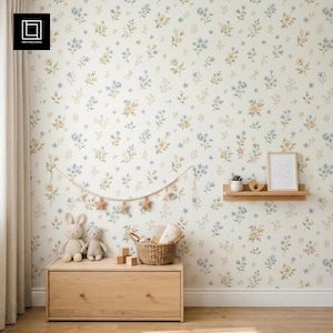 May include: A nursery interior featuring floral wallpaper in cream, blue, and yellow. A wooden chest of drawers holds soft toys and a wicker basket. A wooden shelf displays a framed print and a small plant. A star garland hangs.