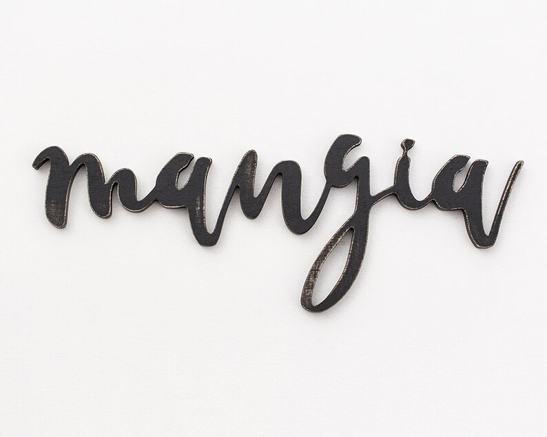 May include: Black wooden sign with the word "mangia" written in cursive script.