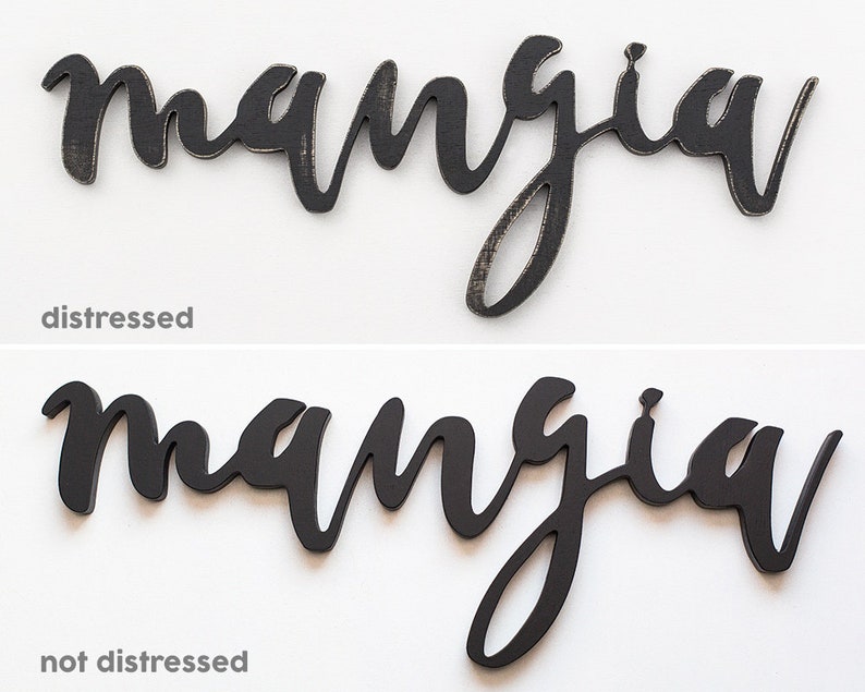 May include: Two wooden signs with the word "mangia" written in black script. The top sign has a distressed finish, while the bottom sign has a smooth, black finish.