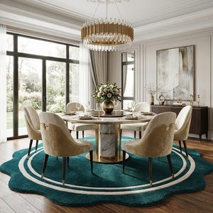 May include: A round dining table with a white marble base and gold accents, surrounded by six upholstered chairs in beige and tan fabric. The set sits on a large, scalloped, teal-colored area rug with white circular detailing on a wooden floor.