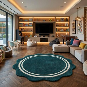 May include: A large, round, dark teal area rug with a scalloped edge and two concentric white circular lines in the center. The rug is placed on a dark brown herringbone wood floor in a spacious room featuring a sectional sofa and shelving.