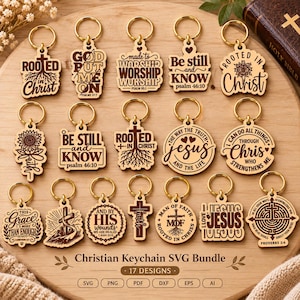 May include: Seventeen wooden keychains with engraved Christian phrases and symbols, including crosses, sunflowers, and Bible verses. Each keychain features a gold-toned metal ring. The text includes phrases like Rooted in Christ, Be Still and Know, and I Love Jesus, arranged on a wooden surface with a label reading Christian Keychain SVG Bundle.