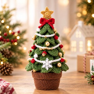 May include: A crocheted Christmas tree in a brown pot, featuring green layered leaves, a yellow star topper, a red bow, white crocheted garland, small gold spherical ornaments, red pom-poms, and a white crocheted snowflake ornament.