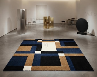 May include: A rectangular area rug featuring a geometric pattern of interlocking blocks in shades of deep navy blue, tan, black, and cream. The design consists of solid-colored squares and rectangles arranged in a structured, repeating grid layout.