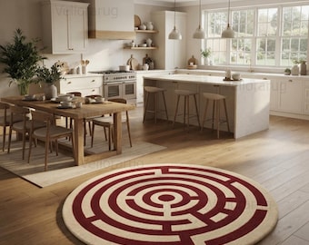May include: A round area rug featuring a cream-colored background with a bold, dark red maze pattern. The circular rug is positioned on a light-toned wooden floor in a kitchen setting, showcasing a geometric labyrinth design.