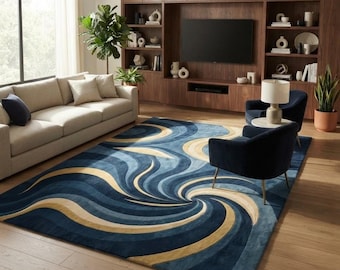 May include: A large rectangular area rug featuring a dynamic swirling pattern in shades of deep navy blue, light blue, and soft beige. The design consists of curved, wave-like bands that radiate from a central point, creating a sense of motion.