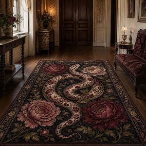 May include: A rectangular area rug featuring a dark background with a large, coiled snake in the centre. The design includes detailed, oversized floral motifs in shades of deep red, pink, and muted green, arranged symmetrically around the central serpent.