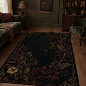 May include: A rectangular area rug featuring a dark black background with a botanical print of flowers and leaves in shades of deep red, muted green, and cream. The rug has a decorative border with gold-toned scrollwork patterns on the corners.