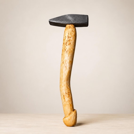 A fully functional wooden hammer carved from rare curly birch — the grain patterns make every single one a one-of-a-kind piece of Nordic craft art.