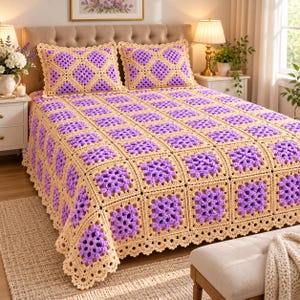 May include: A handmade crochet bedspread and two matching pillow shams featuring a repeating square pattern. The design consists of vibrant purple centers framed by light beige yarn borders, finished with a decorative scalloped edge trim.