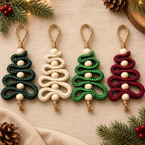 May include: Four hanging ornaments shaped like Christmas trees, each crafted from a continuous length of braided cord in dark green, cream, bright green, and deep red, accented with five round wooden beads and a jute rope loop at the top.