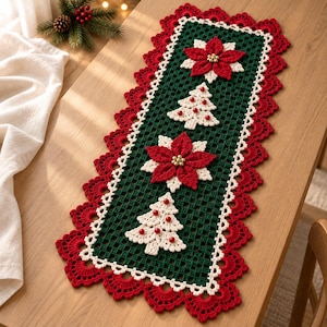 May include: A rectangular crochet table runner featuring a dark green grid center with alternating red poinsettia flowers and white Christmas tree motifs. The runner is bordered by a white trim and a wide, scalloped red crochet edge.
