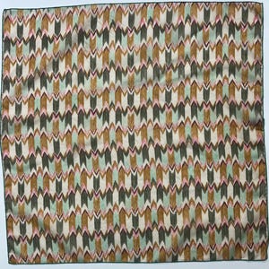 May include: A square scarf featuring a repeating chevron pattern in shades of olive green, mustard yellow, soft mint green, and pale pink on an off-white background. The fabric has a visible texture and is finished with a dark green stitched edge.