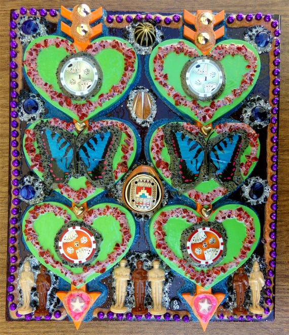 A signed, one-of-a-kind assemblage of real butterfly specimens and found objects on wood — the kind of wall art that stops every single guest mid-sentence.