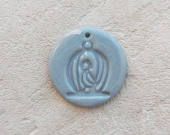 Gray porcelain enamel medal.