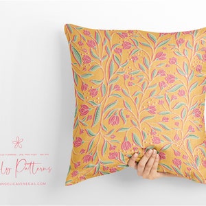 May include: A yellow throw pillow with a pink and green floral pattern. The pillow is being held by a hand. The text "Lovely Patterns" is visible in the bottom left corner of the image.