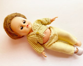 Cosmopolitan Ginger 1950's Doll, Molded plastic, Fully jointed head and, 7 1/2 inch tiny baby doll with 4 outfits.