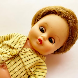 Cosmopolitan Ginger 1950&#39;s Doll, Molded plastic, Fully jointed head and, 7 1/2 inch tiny baby doll with 4 outfits.