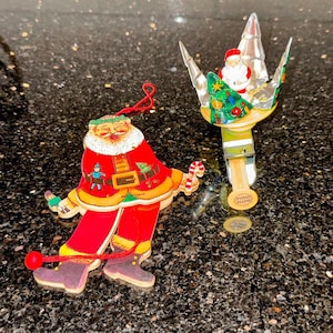 Vintage tin litho spinning Christmas tree with Santa and Santa Pull String Ornament