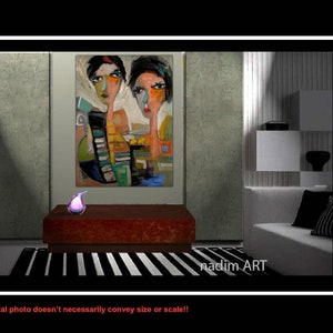 May include: Abstract painting of two women with colorful geometric shapes and patterns. The painting is framed and hanging on a wall in a modern living room setting. The painting is signed "nadim ART".