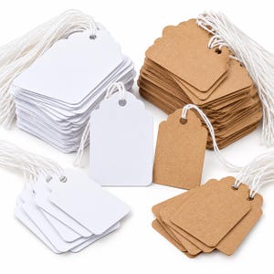 May include: A collection of rectangular paper tags with scalloped tops and pre-punched holes, featuring white and brown kraft paper options. Each tag is attached to a length of white string, organised into several small stacks and individual pieces.
