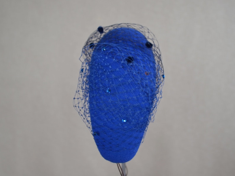 May include: A blue felt hat with a blue netting veil and blue sequins.