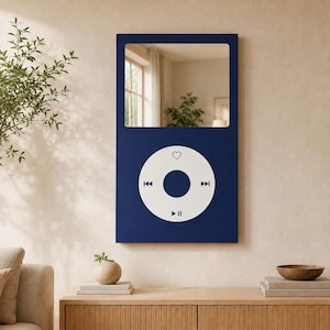 May include: A rectangular wall mirror featuring a dark blue frame designed to resemble a classic digital music player. The upper portion is a reflective glass mirror, while the lower section displays a white circular control interface.