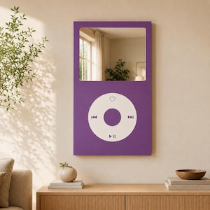 May include: A rectangular purple wall mirror designed to resemble a digital music player. The upper section features a reflective glass surface, while the lower section displays a white circular control interface with a heart, skip, and play icons.