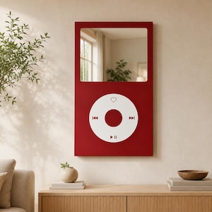 May include: A rectangular wall mirror with a deep red frame designed to resemble a classic digital music player. The top section features a reflective glass surface, while the bottom section displays a white circular control interface.