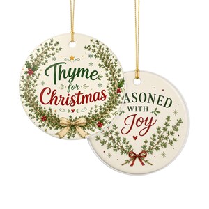 May include: Two round ceramic ornaments with gold hanging strings. One features a green thyme wreath, a beige bow, and the text "Thyme for Christmas". The other displays green thyme sprigs, a red bow, and the text "SEASONED WITH JOY".