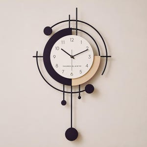May include: A wall clock featuring a circular white face with black numerals and the text TOMORROW WILL BE BETTER. The clock is framed by black metal geometric arcs, lines, and circular accents, with a long pendulum extending from the bottom.
