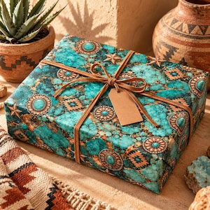 May include: A rectangular gift box wrapped in paper featuring a turquoise stone pattern with copper-colored star and circular accents. The box is tied with a tan suede cord and includes a blank, rectangular, light brown paper gift tag.