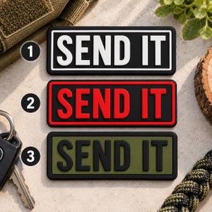May include: Three rectangular patches with the text SEND IT in raised lettering. The first patch is black with white text, the second is black with red text, and the third is olive green with black text. Each patch has a black border.