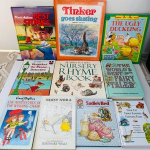 May include: A collection of ten children's storybooks arranged in three rows. Titles include Uncle Arthur's Best Stories, Tinker Goes Skating, The Ugly Duckling, Roquefort the Mouse, Detective, Beatrix Potter's Nursery Rhyme Book, The World's Best Fairy Tales, The Adventures of the Wishing-Chair, Noisy Nora, Sadie's Bed, and Four Fat Frogs Fanning Fainting Flies.