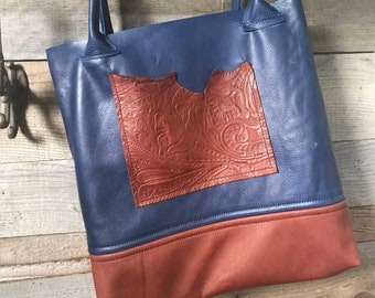 Navy leather tote with embossed whiskey pockets