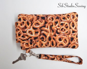 Pretzels Smartphone Wristlet, Fits iPhone 15, 14, 13, Smartphones up to 6.25" x 3.25", Key Ring, Pocket, Pretzel Phone Wristlet, Snack Purse