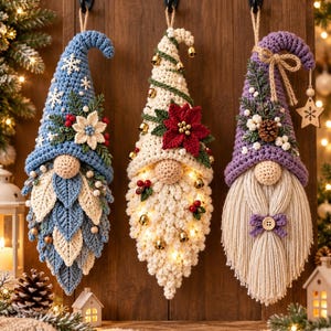 May include: Three hanging crochet gnome ornaments. The left gnome has a blue hat with snowflakes and a leaf-patterned beard. The center gnome has a cream hat with bells, a red poinsettia, and integrated warm lights. The right gnome has a purple hat.