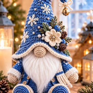 May include: A crocheted gnome figurine wearing a blue hat decorated with white snowflakes, pearls, a cream-colored flower, pinecones, and greenery. The gnome has a long white beard, a beige nose, and a blue outfit with a white scarf and small buttons.
