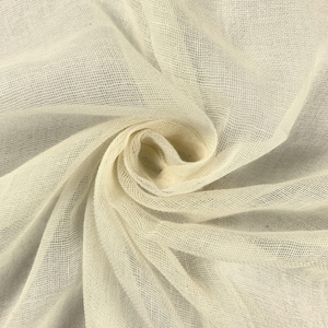 May include: A close-up of a white, sheer fabric with a woven texture. The fabric is folded and draped, creating a soft, flowing look.
